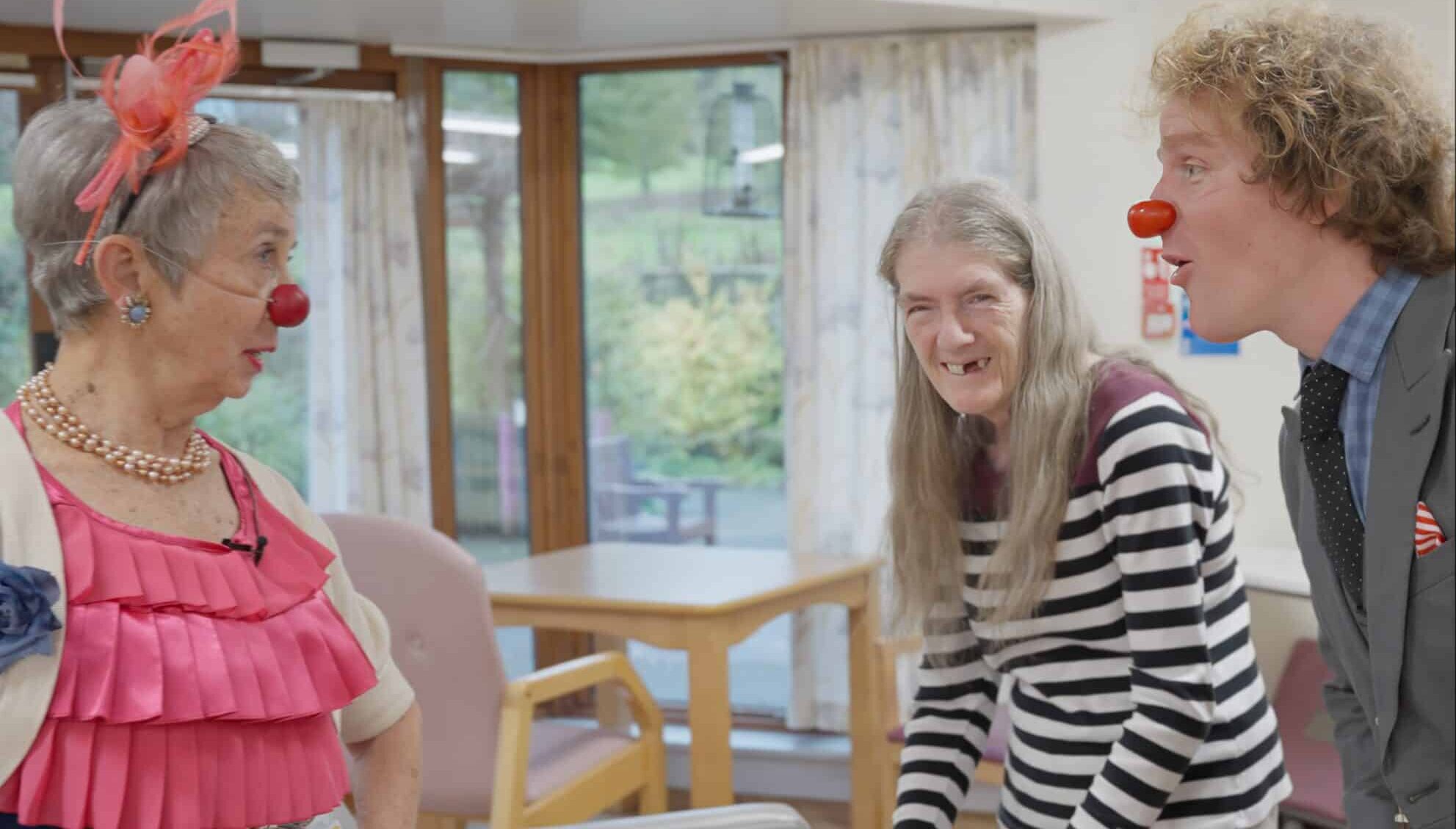 Handsome and Dipsy Elderflower disagree about something while a lady in her 60's laughs in between them